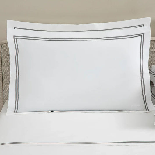 front view of classic pillowcase sham white grey on a bed