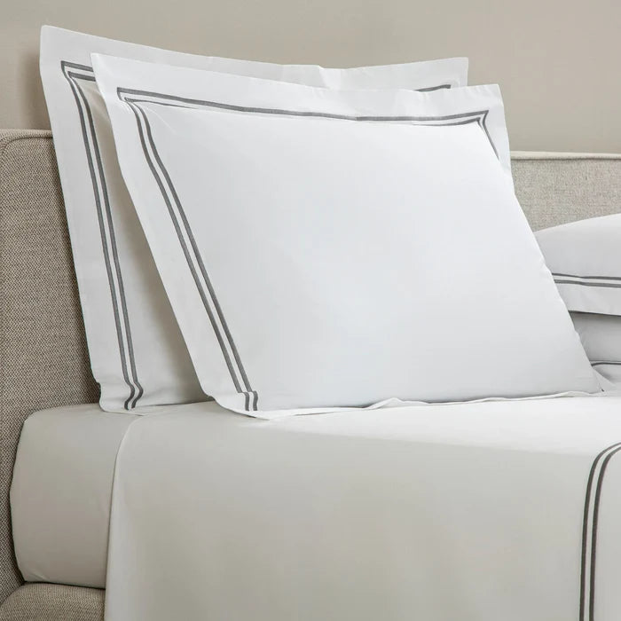 side view of classic pillowcase sham white grey on a bed