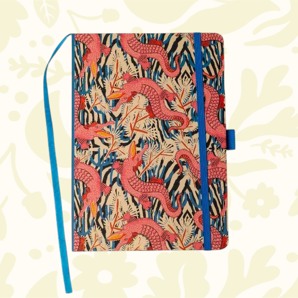 Forager Provisions LTD Denik hardbound notebook with pink alligator animal print, blue elastic closure, and bookmark.