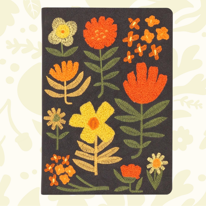 Forager Provisions LTD Denik journal with a black cover featuring textured, chunky folk-style embroidered flowers.