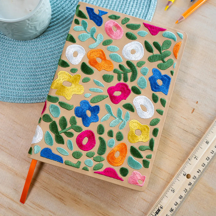Forager Provisions LTD Denik journal with a tan cover featuring colourful embroidered floral spring garden designs.