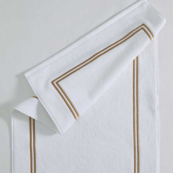 Empire Bath Mat White Gold on a light gray background