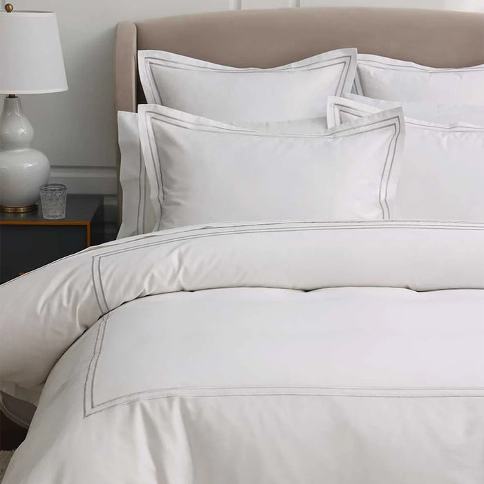 Neatly made bed with Empire Silver Duvet Cover set in a bedroom setting.