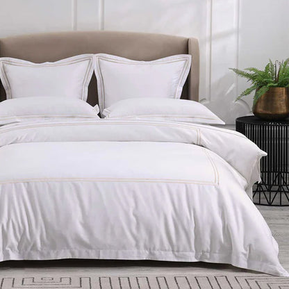 Empire Champagne Duvet Cover set on a bed with a neutral headboard and decorative elements.
