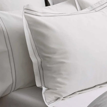 Close-up of Empire Silver Pillowcases on a bed