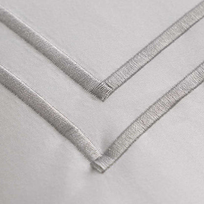 Close-up of Empire Silver Pillowcase on a light gray background