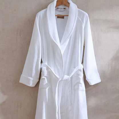 Empire Velour White / White Bath robeon a hanger against a beige background