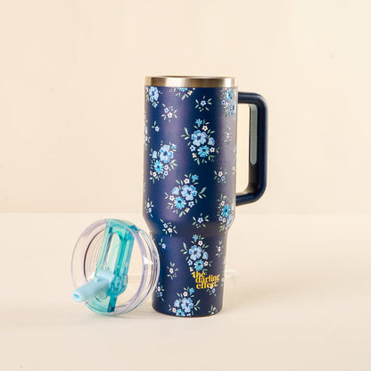 The-darling-effect's Endless Daydream Navy 40 oz Lifestyle Flip Straw Tumbler features a floral pattern, clear leak-resistant lid, and turquoise straw for a stylish and functional drinkware choice.