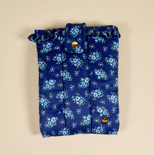 The Darling Effect's Endless Daydream Navy Book Cover features a quilted floral design and ruffled edges in navy blue, with a gold snap closure to protect your favorite reads and double as a stylish pouch.