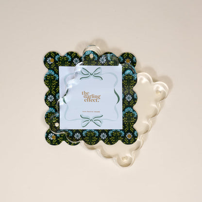 The Darling Effect Everbloom Forest Green Square Scalloped Acrylic Picture Frame features a modern floral design, a clear top layer, and "4X4 PHOTO FRAME" printed at the center.