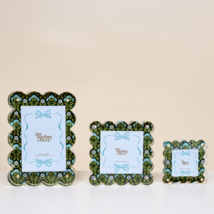 Three Everbloom Forest Green Square Scalloped Acrylic Picture Frames by The Darling Effect are shown in small, medium, and large sizes on a beige background, each featuring a blue card with a bow and text.