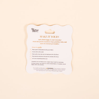 A product instruction card titled MAKE IT YOURS in orange text by The Darling Effect offers directions for applying the Farm Fresh Strawberries Mix & Match Iron-On Patch, so you can customize fabric items. Safety and website info appears at the bottom.