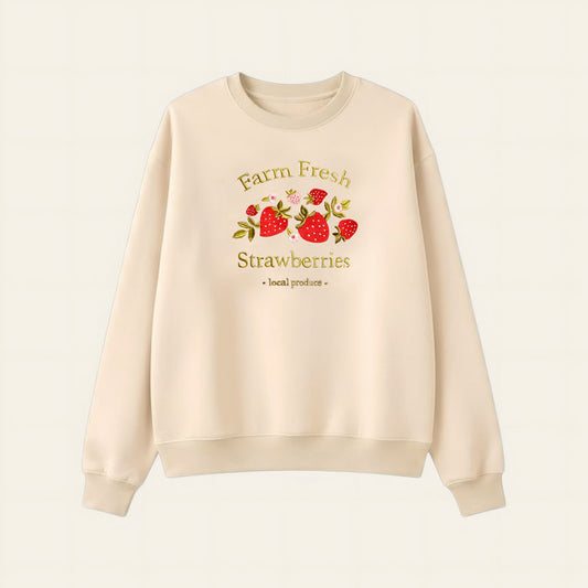 The Darling Effect’s Farm Fresh Strawberries Signature Crew is a cream sweatshirt with embroidered strawberries and “Farm Fresh Strawberries - local produce,” designed for all-day comfort and a timeless look.