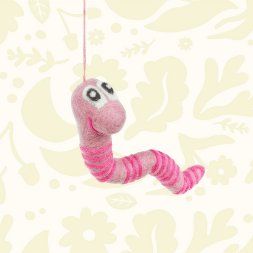 Forager Provisions LTD handmade pink felt worm decoration with striped pattern and hanging string on floral background