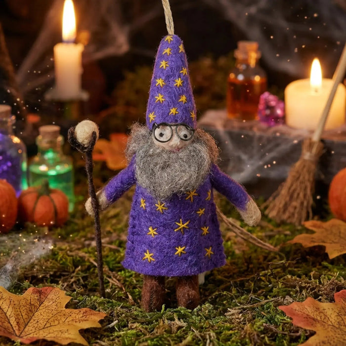 Felt So Good Wendall the Wizard felt decor in a starry robe, surrounded by candles, leaves, bottles, and pumpkins.