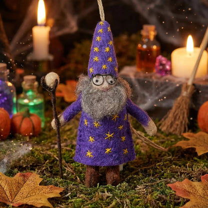 Felt So Good Wendall the Wizard felt decor in a starry robe, surrounded by candles, leaves, bottles, and pumpkins.