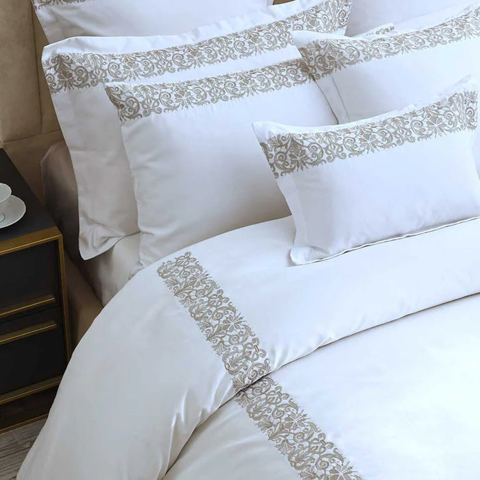 Fion Taupe Duvet Cover Set on a bed in a bedroom setting.