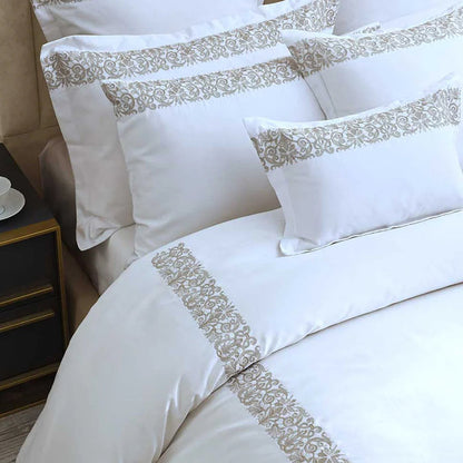 Fion Taupe Duvet Cover Set on a bed in a bedroom setting.