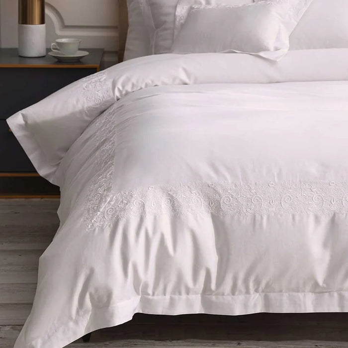 Fion White Duvet Cover Set on a bed in a bedroom setting.