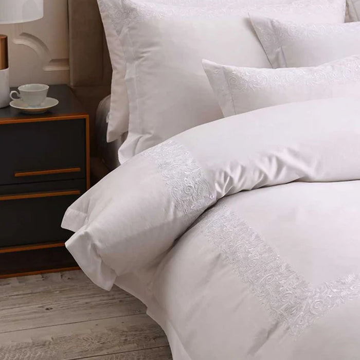 Fion White Duvet Cover Set on a bed in a bedroom setting.