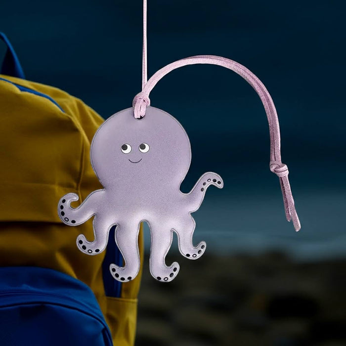 Forager Provisions LTD Firefly Sweden octopus shaped reflective bag charm in light purple hanging on a backpack