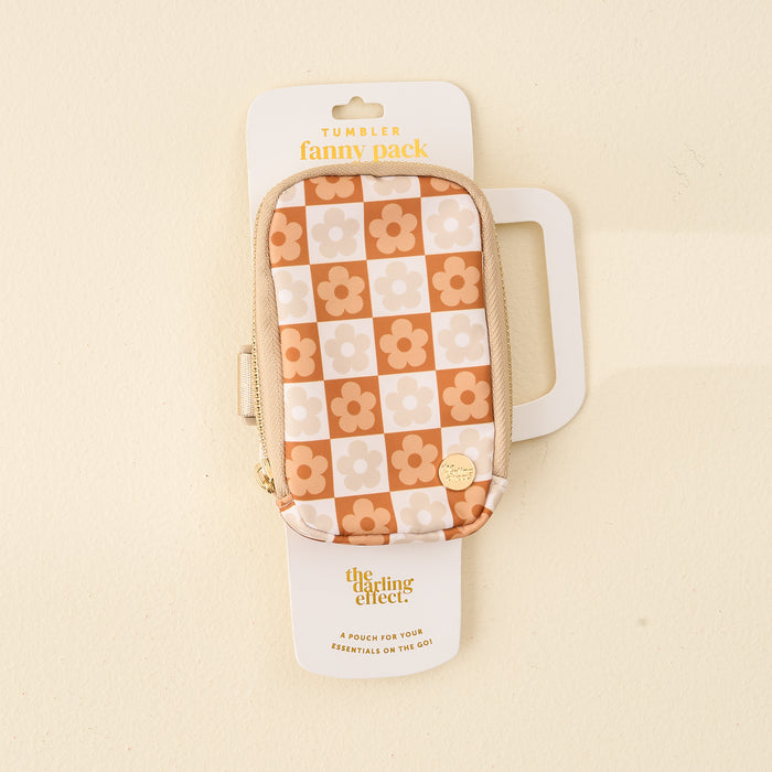 The Darling Effect’s Flower Check Brown Tumbler Fanny Pack is a stylish, water-resistant pouch with a beige zipper and retro orange and cream checkerboard flower pattern, shown packaged against a light background.