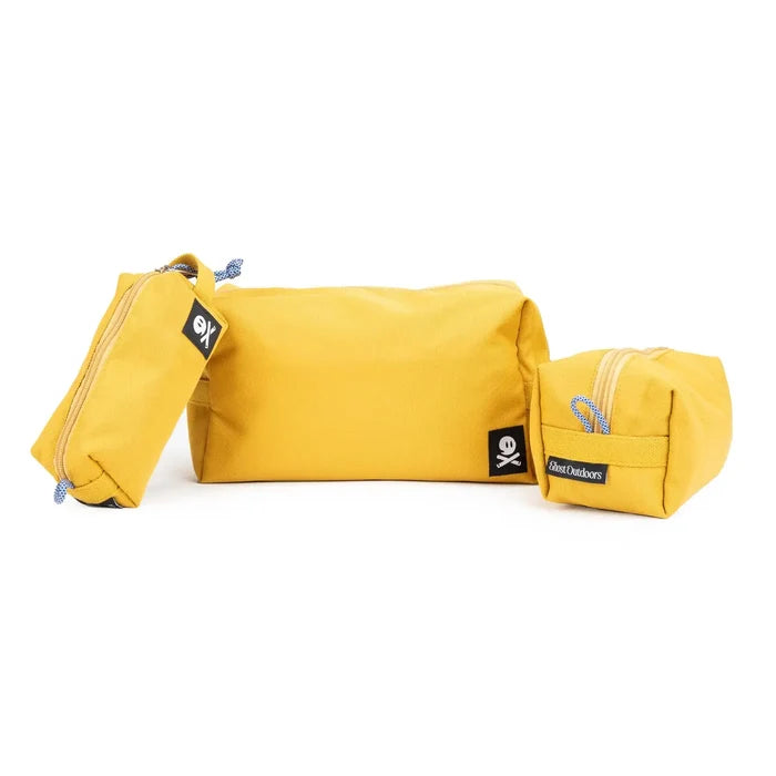Three Ghost Outdoors Ochre Yellow Dopp Kits displayed side by side on white background, premium travel toiletry bags.