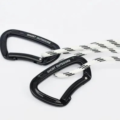 Ghost Outdoors black carabiners attach ropes to Peacock Carry-On Hammock, essential gear on a white background for camping.