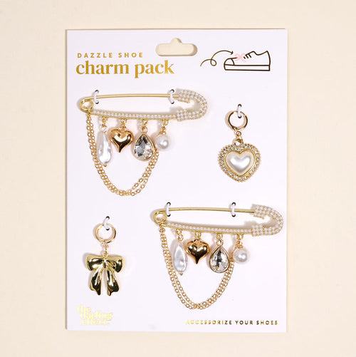The Darling Effect’s Glitz & Glam Dazzle Shoe Charm Pack features two embellished pins with dangling hearts, bows, pearls, and teardrop gems plus two individual charms—a heart and a bow—ideal for adding stylish flair to your shoes.
