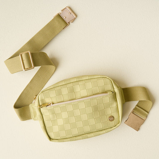 A trendy accessory from The Darling Effect, the Green Urban Check Belt Bag features a checkered pattern, gold zipper, and adjustable strap on a stylish cream background.