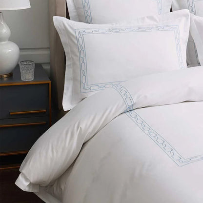 Hamilton Light Blue Duvet Cover Set on a bed in a bedroom setting.