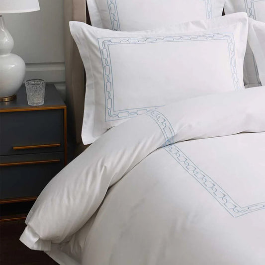 Hamilton Light Blue Duvet Cover Set on a bed in a bedroom setting.