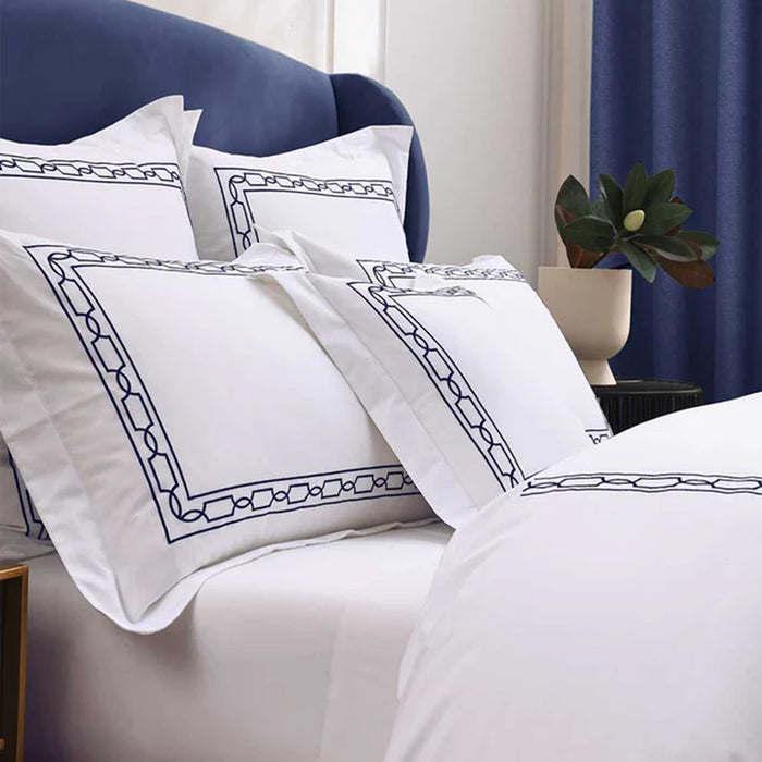 Hamilton Navy Duvet Cover Set on a bed in a bedroom setting.