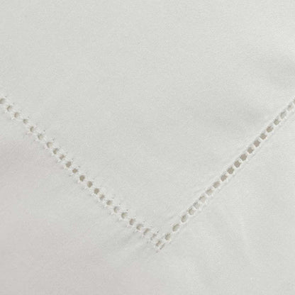 Close-up of Heirloom Picot Stitch Ivory Flat Sheet on a white background
