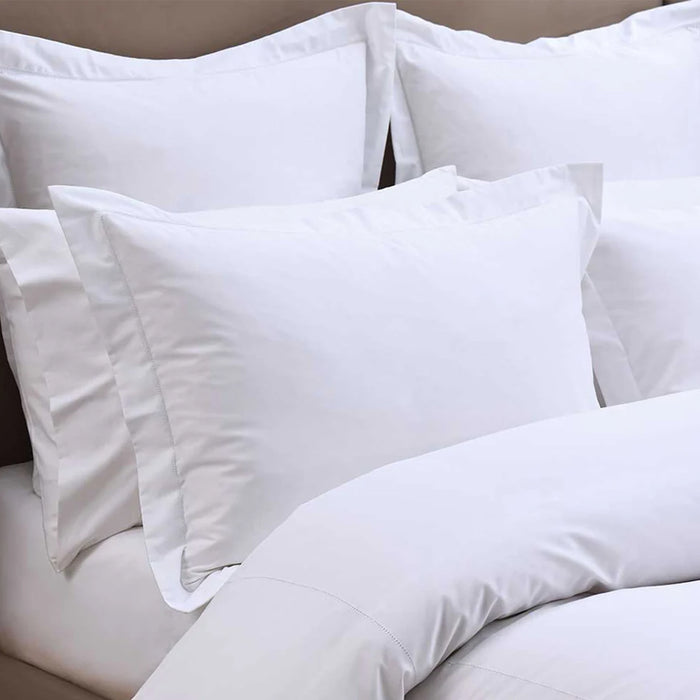 Heirloom Picot Stitch White Pillowcase on a bed