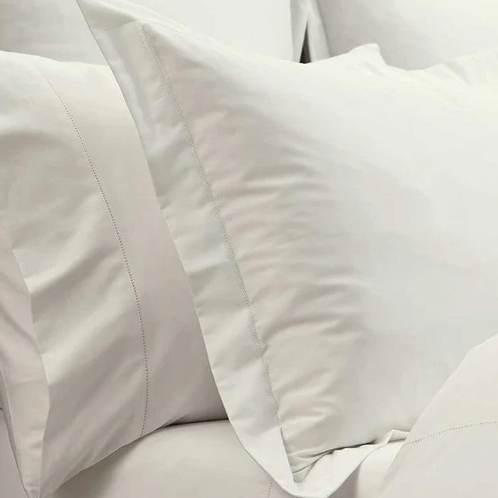 Close-up of Heirloom Picot Stitch Ivory Pillowcase and comforter.