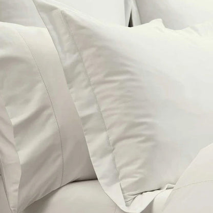 Close-up of Heirloom Picot Stitch Ivory Pillowcase and comforter.