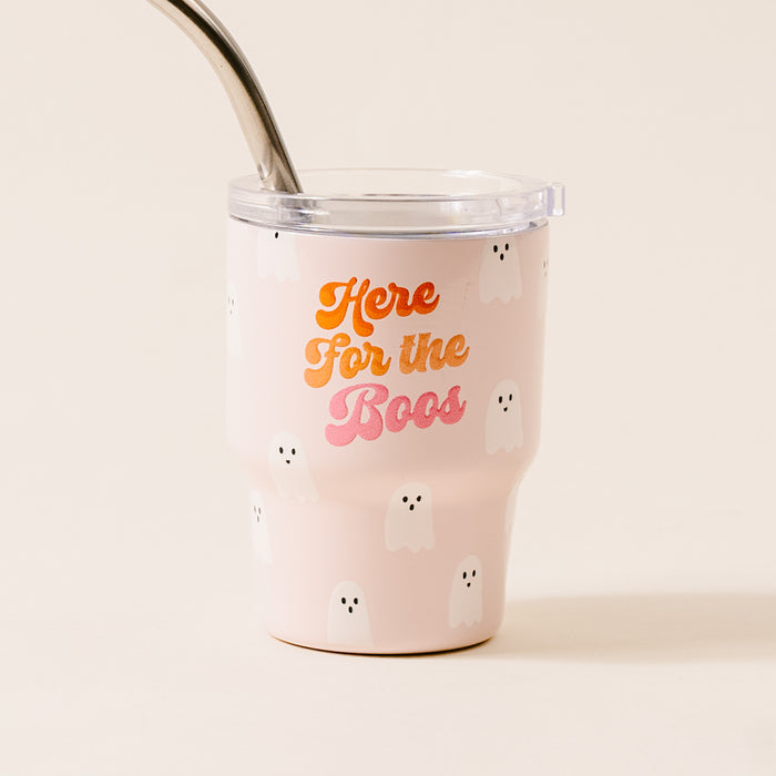 The Darling Effect's Here for the Boos 2 oz Tiny Tumbler features light pink color, white ghost illustrations, and "Here for the Boos" in orange and pink. Comes with a clear lid and metal straw—perfect for festive Halloween sipping.