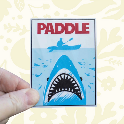 Forager Provisions LTD Hey Bear Outdoors Jaws sticker featuring a shark beneath a kayaker on a light blue background.