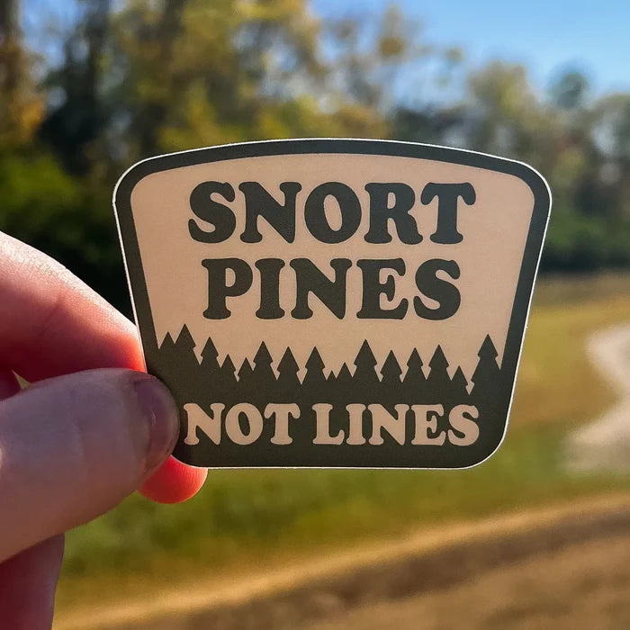 Hand shows Hey Bear Outdoors Snort Pines Not Lines sticker, ideal for hiking, camping, and outdoor adventure fans.