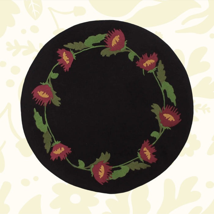 Primitive Folk Flowers In Firkin mat with black, red flowers and green leaves—perfect rustic cottagecore decor by The Home Collection.
