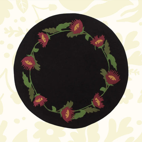 Primitive Folk Flowers In Firkin mat with black, red flowers and green leaves—perfect rustic cottagecore decor by The Home Collection.