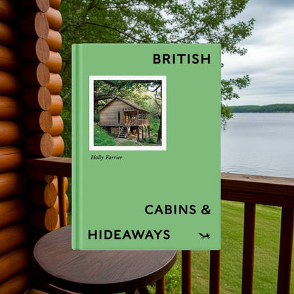 Hoxton Mini Press British Cabins and Hideaways book displayed on a round wooden table, perfect gift for design lovers.