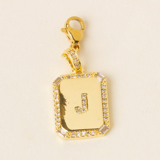 The-darling-effect’s J Jewelry Charm Initial Letter Gold features a gold-plated brass pendant with a diamond-studded border, engraved J center, and secure clasp—ideal for those seeking unique personalized initial jewelry.