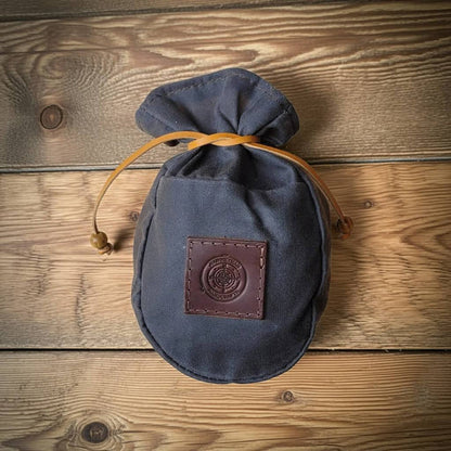 Journeyman Craft grey waxed canvas coffee pouch for camping displayed on wood, durable storage for outdoor enthusiasts.