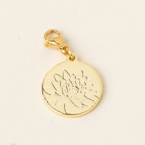 The July Jewelry Birth Flower Charm Gold by the-darling-effect features a gold round charm with a lobster clasp, delicately engraved with a lotus flower—an ideal accessory for birth flower jewelry lovers. Shown on a light, neutral background.