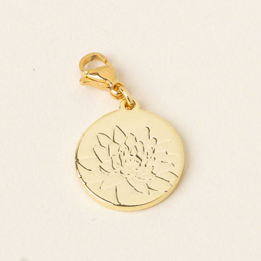 The July Jewelry Birth Flower Charm Gold by the-darling-effect features a gold round charm with a lobster clasp, delicately engraved with a lotus flower—an ideal accessory for birth flower jewelry lovers. Shown on a light, neutral background.
