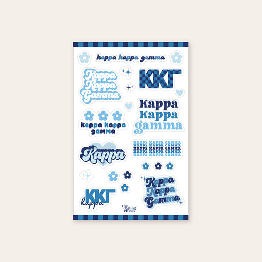 The Darling Effect’s Kappa Kappa Gamma Sticker Sheet features blue, white, and navy stickers with Kappa Kappa Gamma in different fonts, plus flowers, hearts, and stripes—perfect for showing off your sisterhood pride.