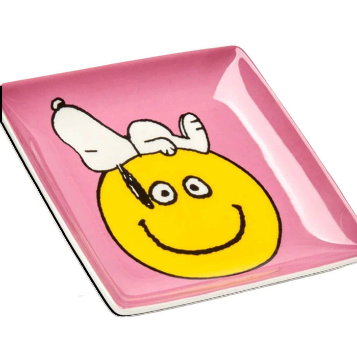 Forager Provisions LTD square ceramic trinket tray featuring a pink background with Snoopy on a yellow smiley face