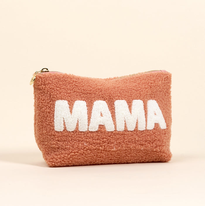 The-darling-effect's Mama 2.0 Teddy Pouch features soft light brown sherpa, a zipper, and bold white "MAMA" lettering on the front, all showcased against a plain beige background.